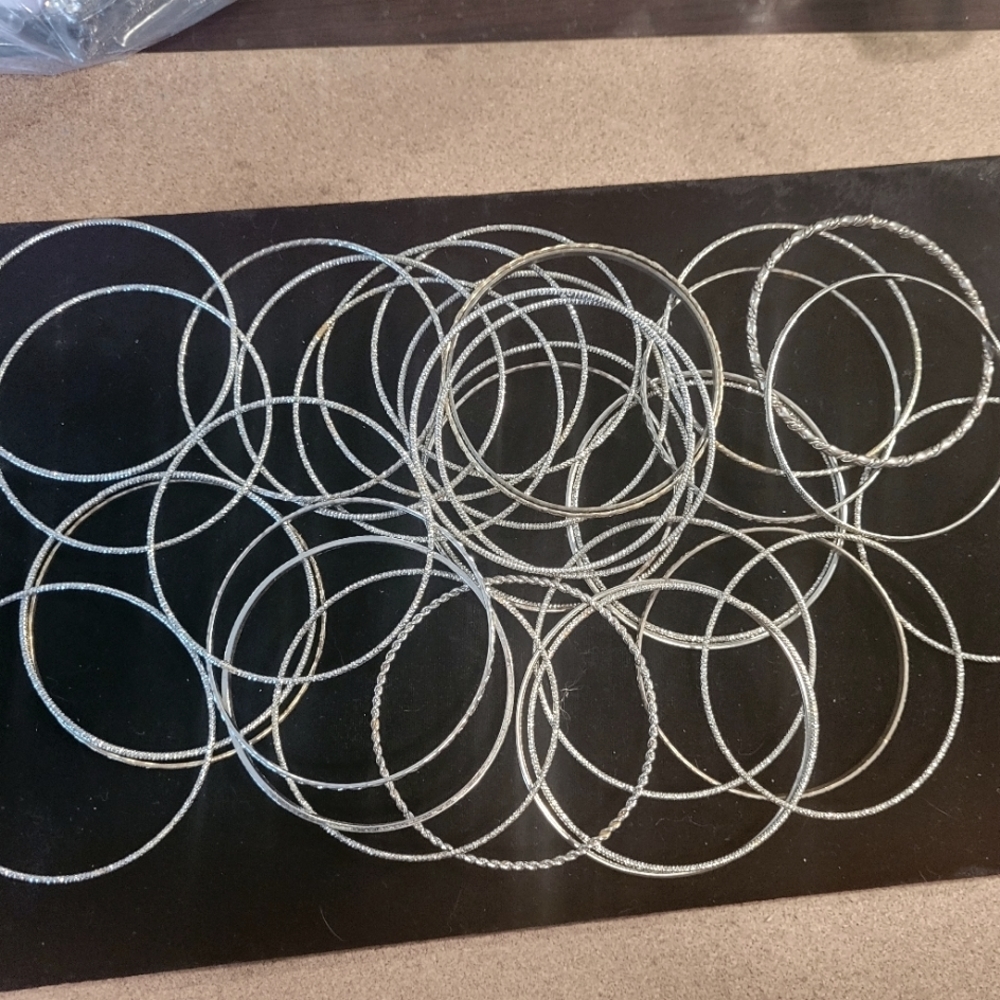 Bangles and more silvertone bangles.  25 +